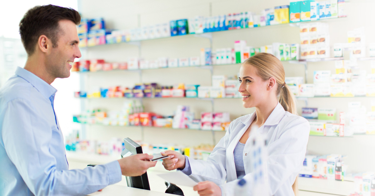 A man purchasing vitamins at a pharmacy